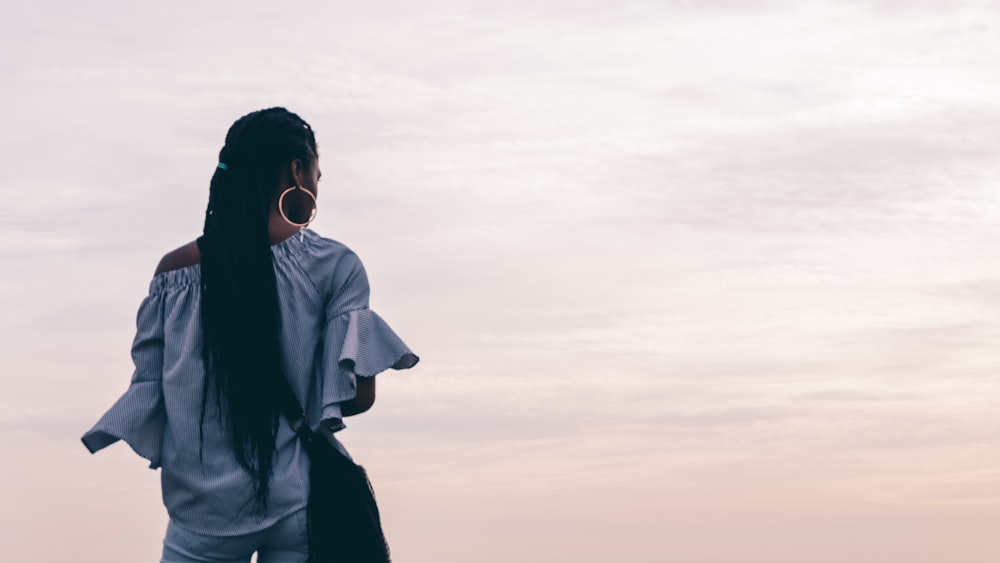 woman standing on seashore during daytime