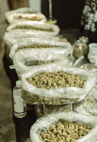 Stacks of neatly packed herbal raw material bags ready for export in a warehouse.