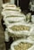A close-up of various types of plastic bags displayed neatly on a table.