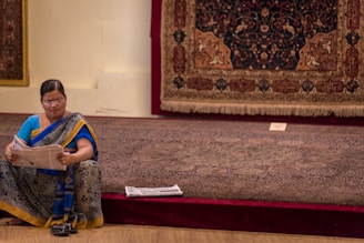 photo of woman sitting and holding newspaper