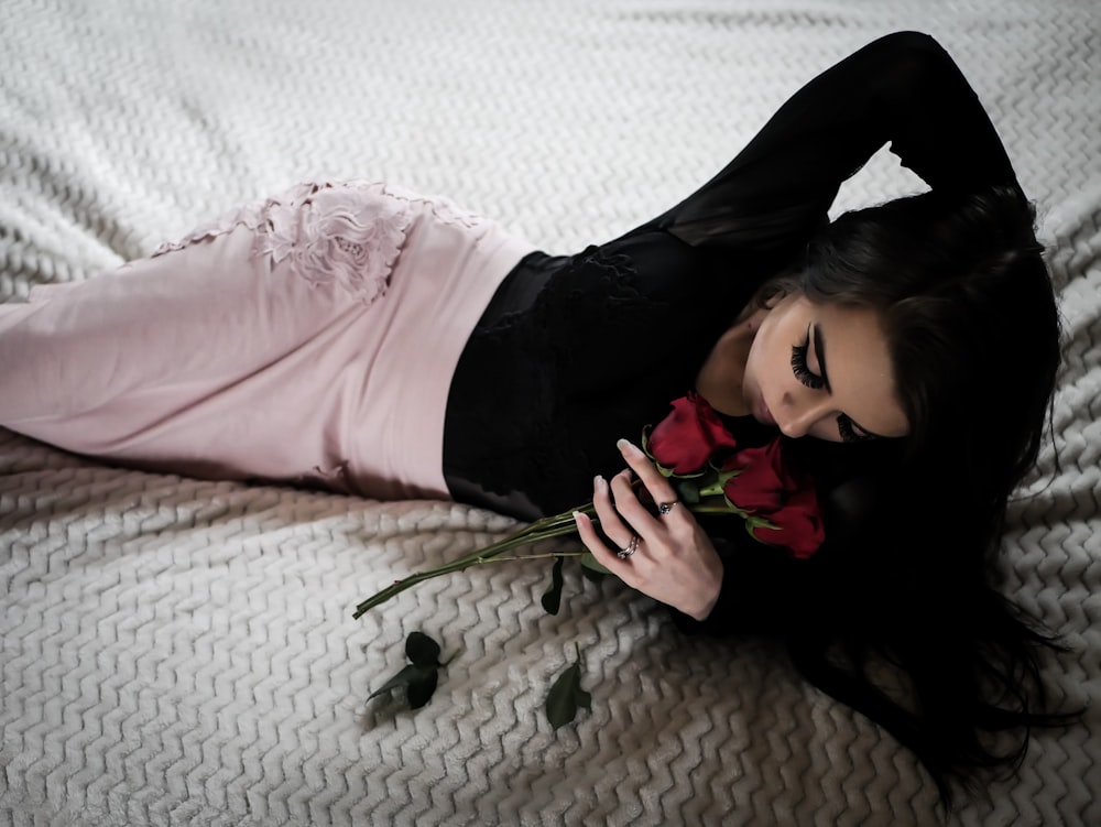 woman holding three roses