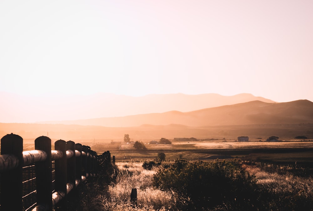 brown wooden fence near mountain