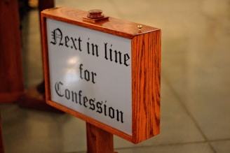 shallow focus photography of brown wooden floor signage