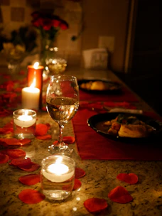 A romantic dinner table lit by soft candlelight, set for two.