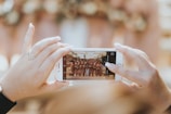 person holding iPhone capturing group of women