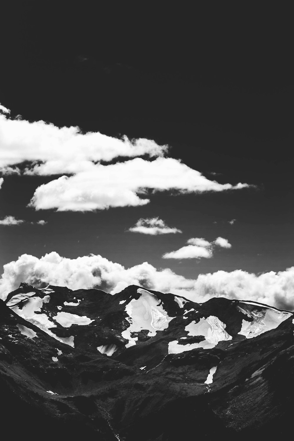 grayscale photo of mountain and clouds