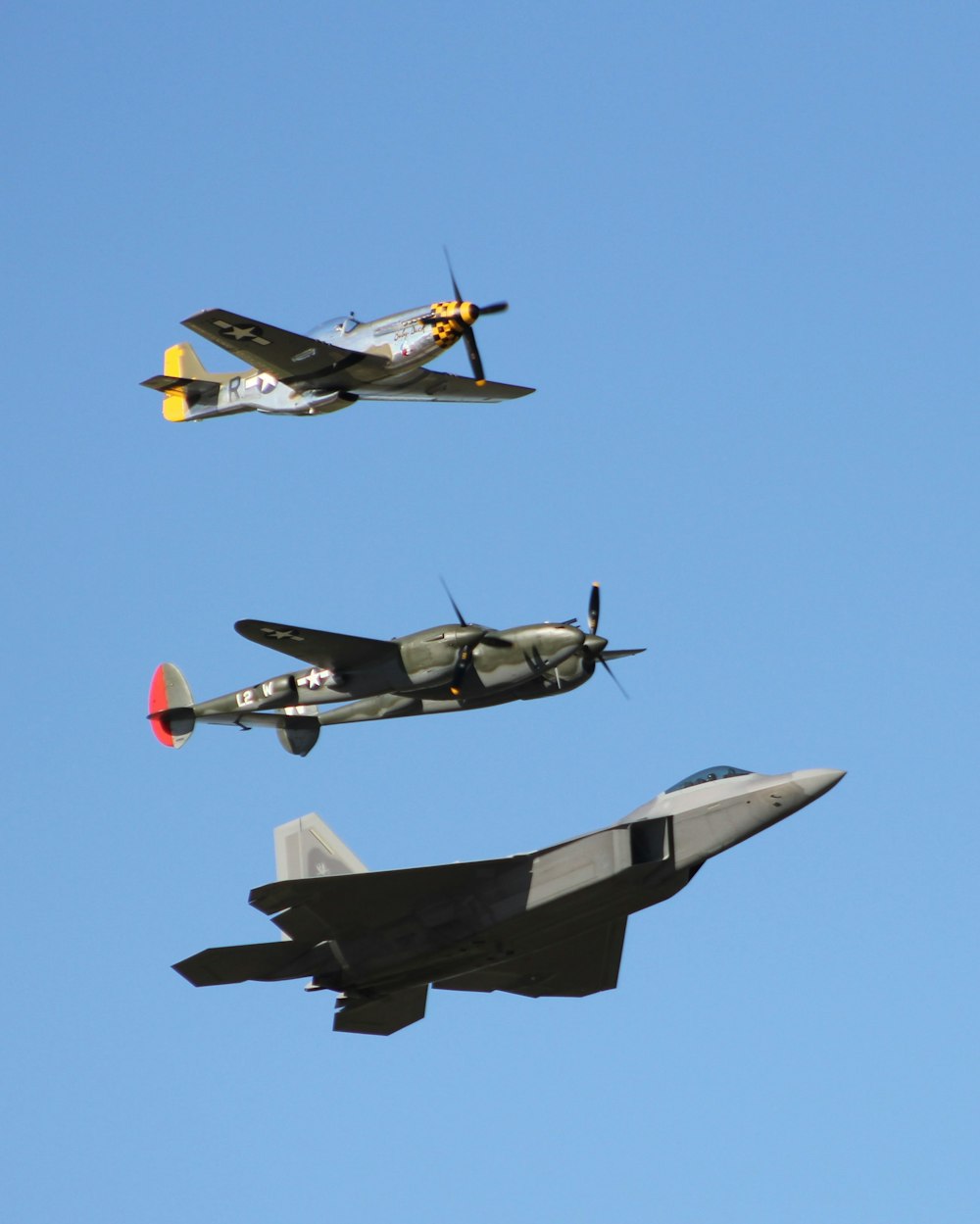 three assorted-color fighter jets