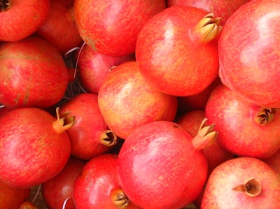 Freshly picked pomegranates glistening under natural light at the fruit store.