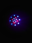 Close-up of LED pixels glowing brightly in a dark environment.