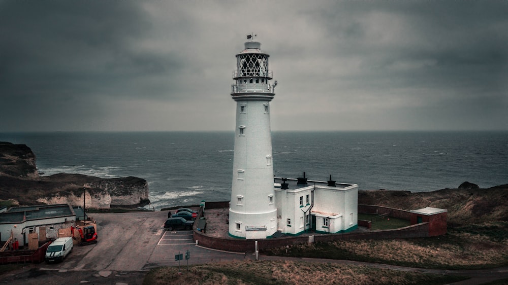 white lighthouse beside beach