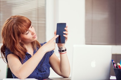 woman holding an android smartphone device teams background