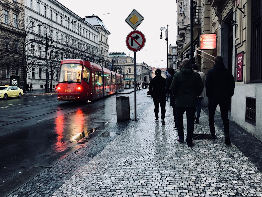 people walking beside street light near lighted signage