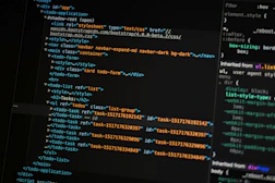 Developer coding a responsive website on multiple screens
