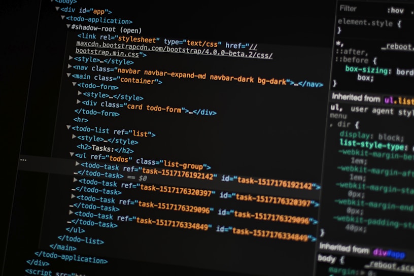 A close-up of a computer screen displays lines of HTML and CSS code. The code includes elements such as a navigation bar, container, and various task items with unique IDs. The screen also shows a styles section with properties like margin and padding.