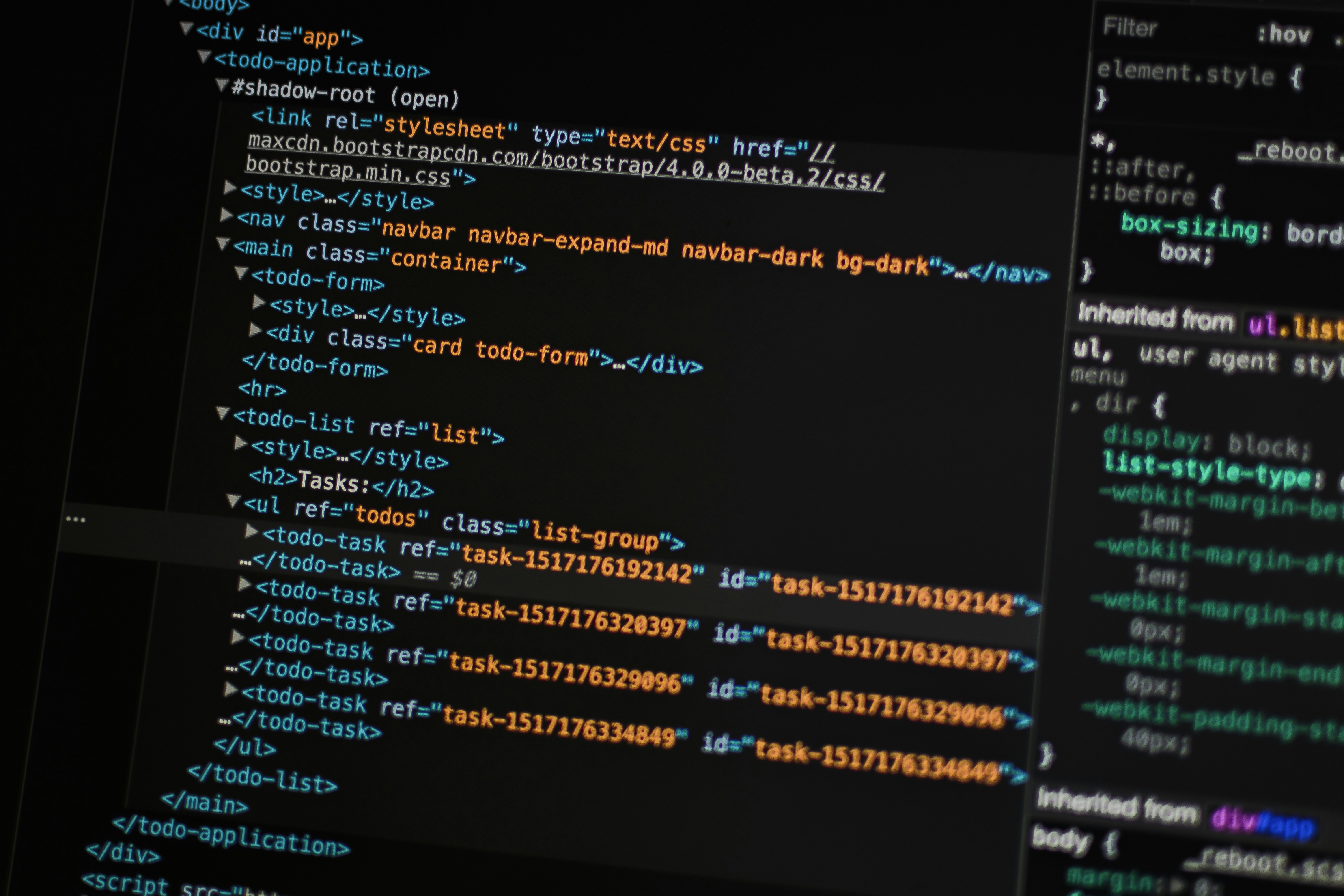 modern workstation laptop displaying code and browser windows in dark mode