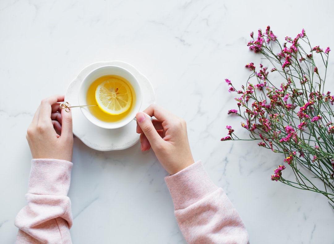 person holding tea filled cup