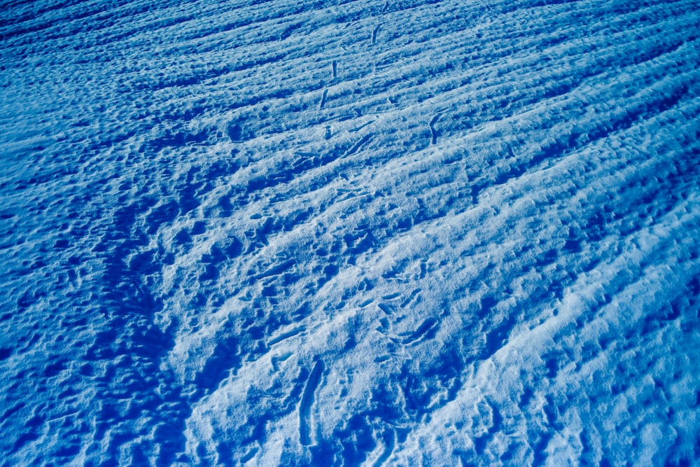 a snow covered slope with lines in the snow