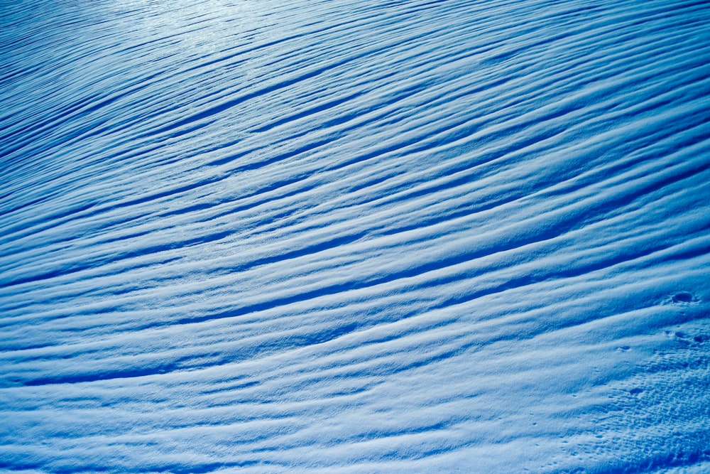 a snowboarder is going down a snowy hill