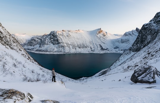 man standing on snow path in Senja Norway