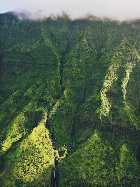 green mountain under white clouds in Hawaii United States