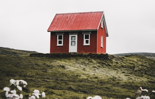 red and white house surround green grass field