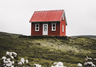 red and white house surround green grass field