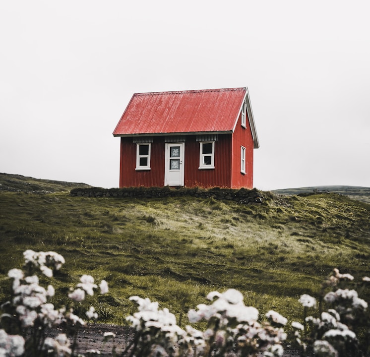 red and white house surround green grass field