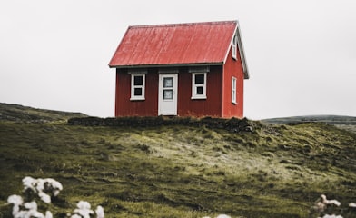 red and white house surround green grass field