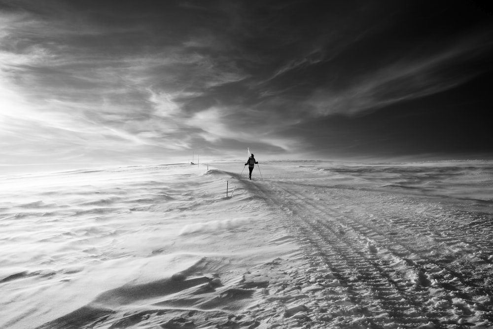 person walking on snow trail