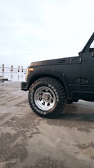 Close-up of the Storm Rider's rugged tires gripping sandy terrain.