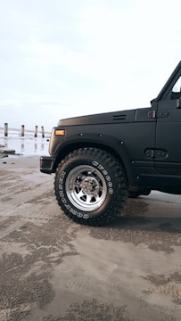Close-up of the Storm Rider's rugged tires gripping sandy terrain.