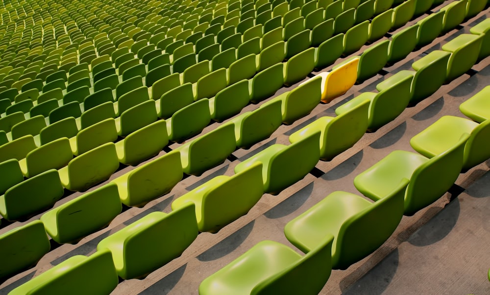 One yellow seat in sea of green seats