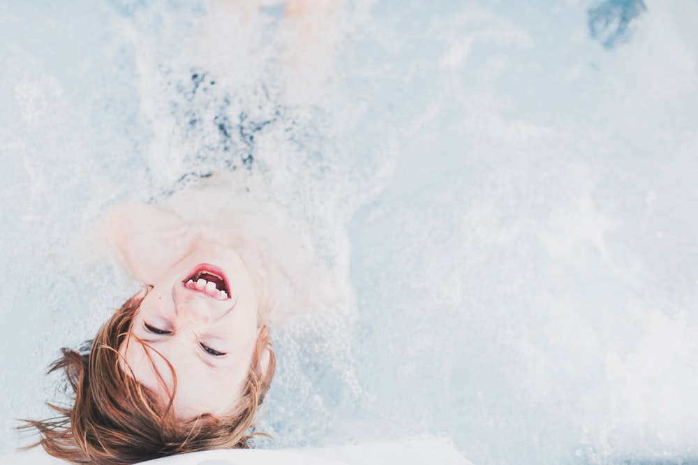 high-angle of kid playing with water