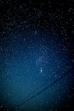 A night sky with subtle constellation lines forming a compass star.