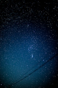 A night sky with subtle constellation lines forming a compass star.