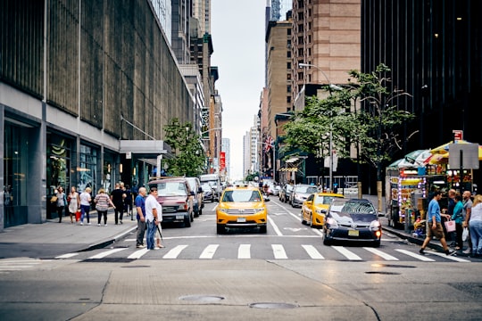 city street with people passing through road in Manhattan United States