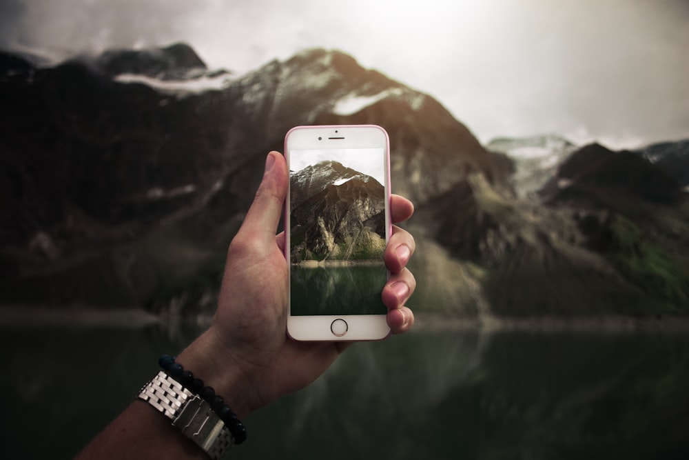 person taking photo on mountain