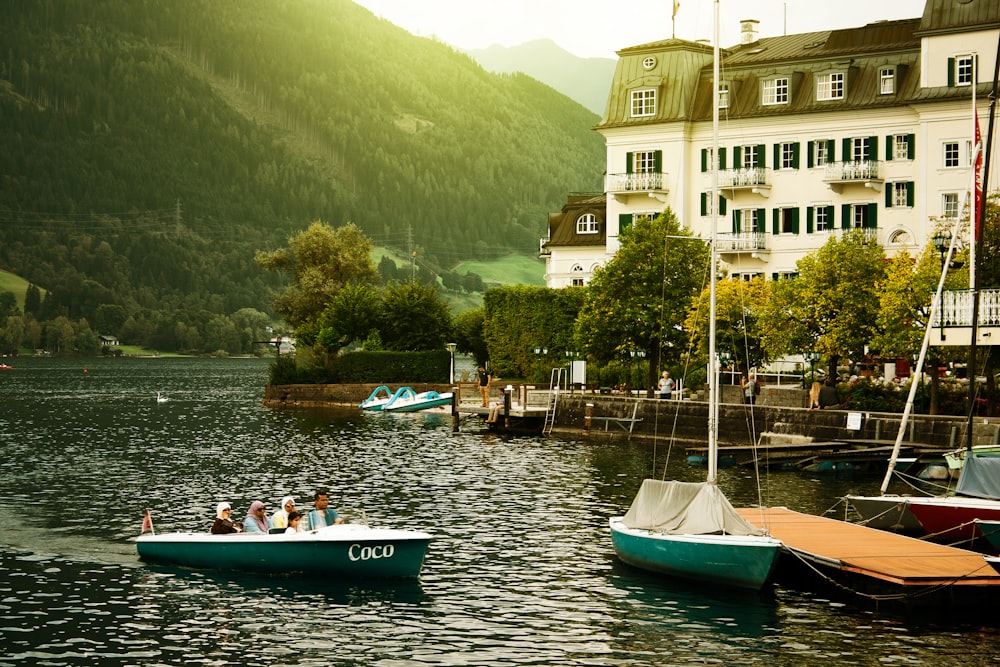 group of people riding on boat near trees and building during daytime