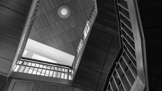 Monochrome technical drawing showing structural details of a contemporary staircase design.