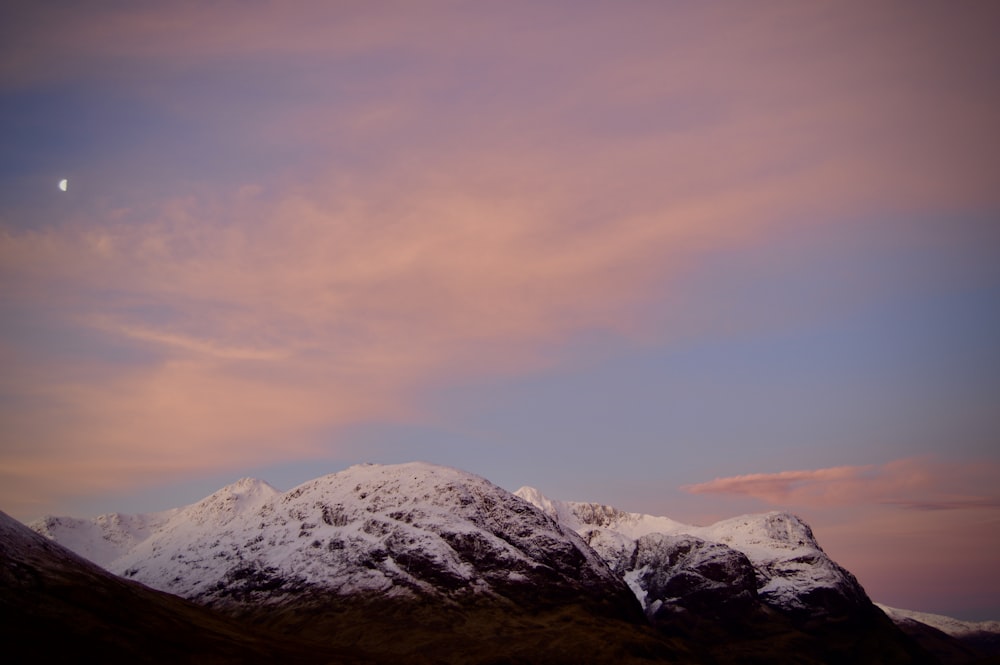 snowy mountain under gray sky