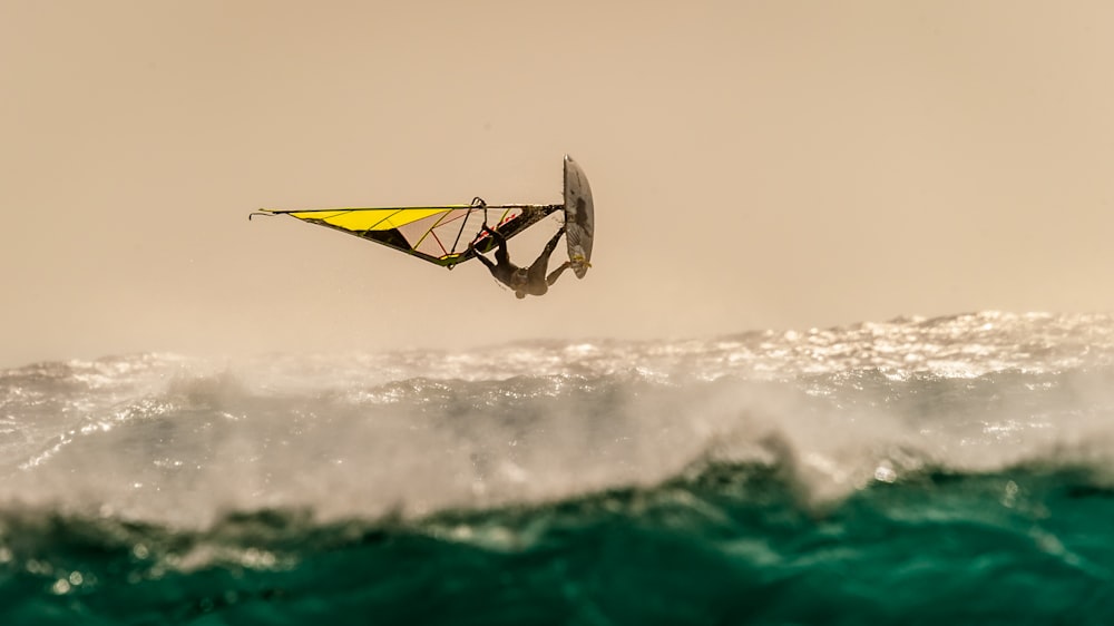 person paragliding during day