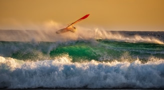 man surfing on top waves