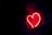 a heart shaped neon sign in the dark