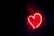a heart shaped neon sign in the dark