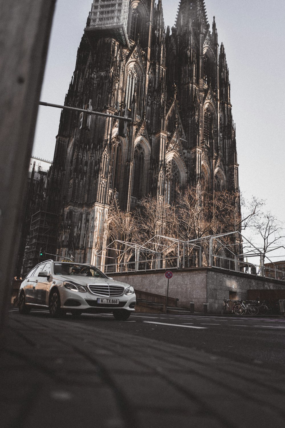 gray car on asphalt road near castle during daytime