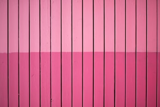 closeup photo of pink paint plank wall