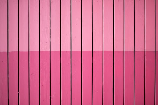 closeup photo of pink paint plank wall