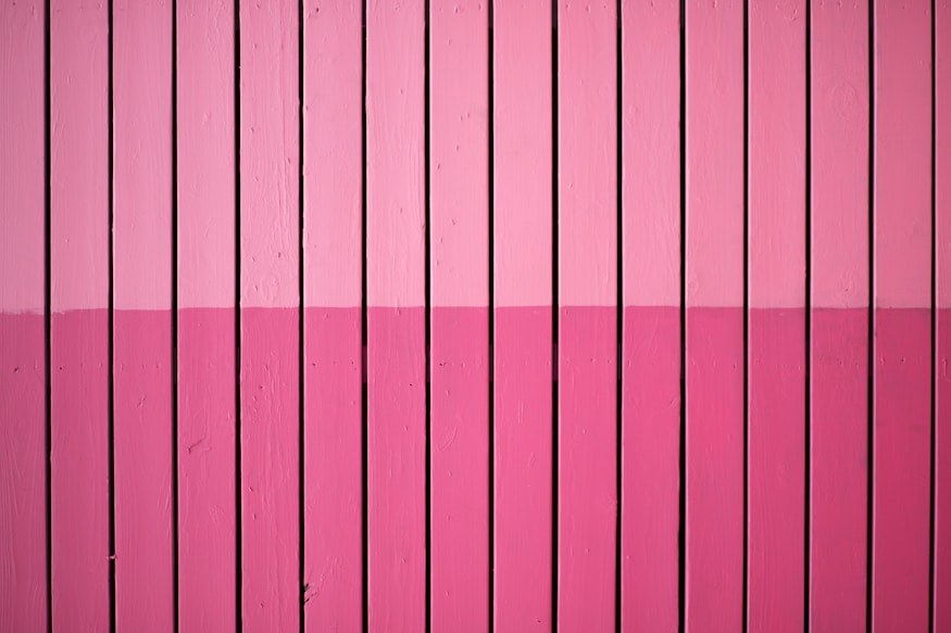 closeup photo of pink paint plank wall