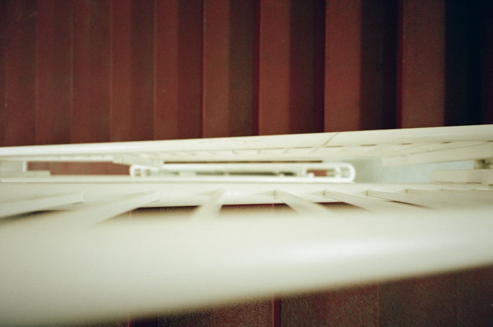 a close up of a white surfboard on a rack