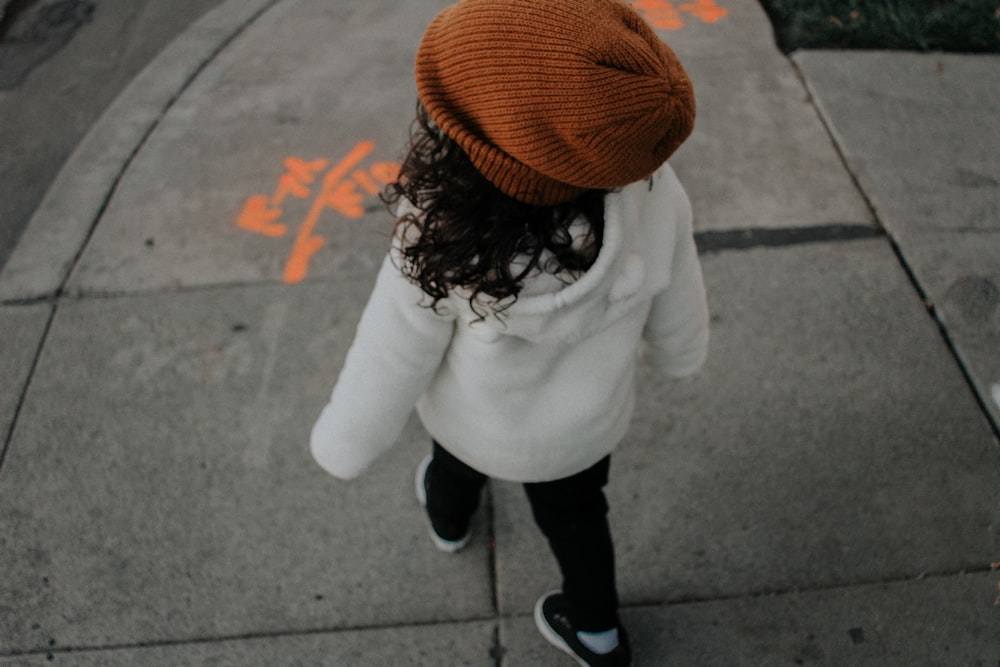 girl walking on side walk in street